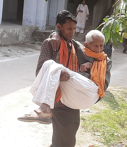 Ram Kishore arrived for election training with his son in his lap.