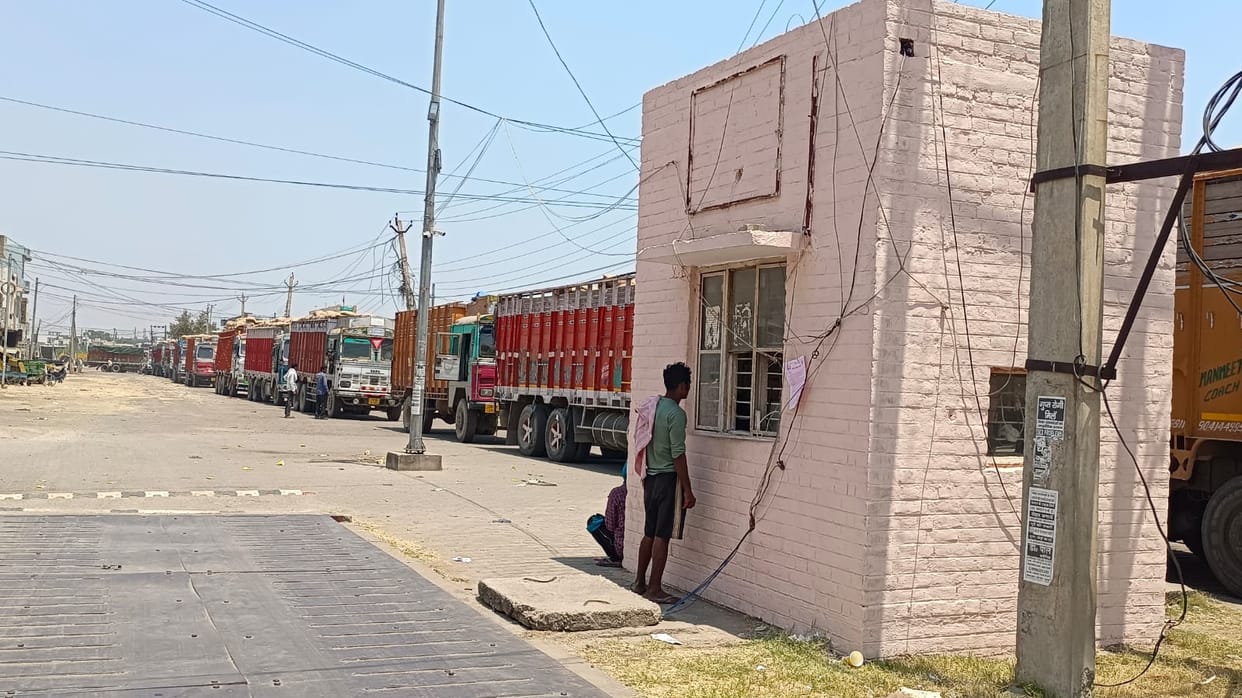 Long queues of trucks carrying wheat from one shed to another