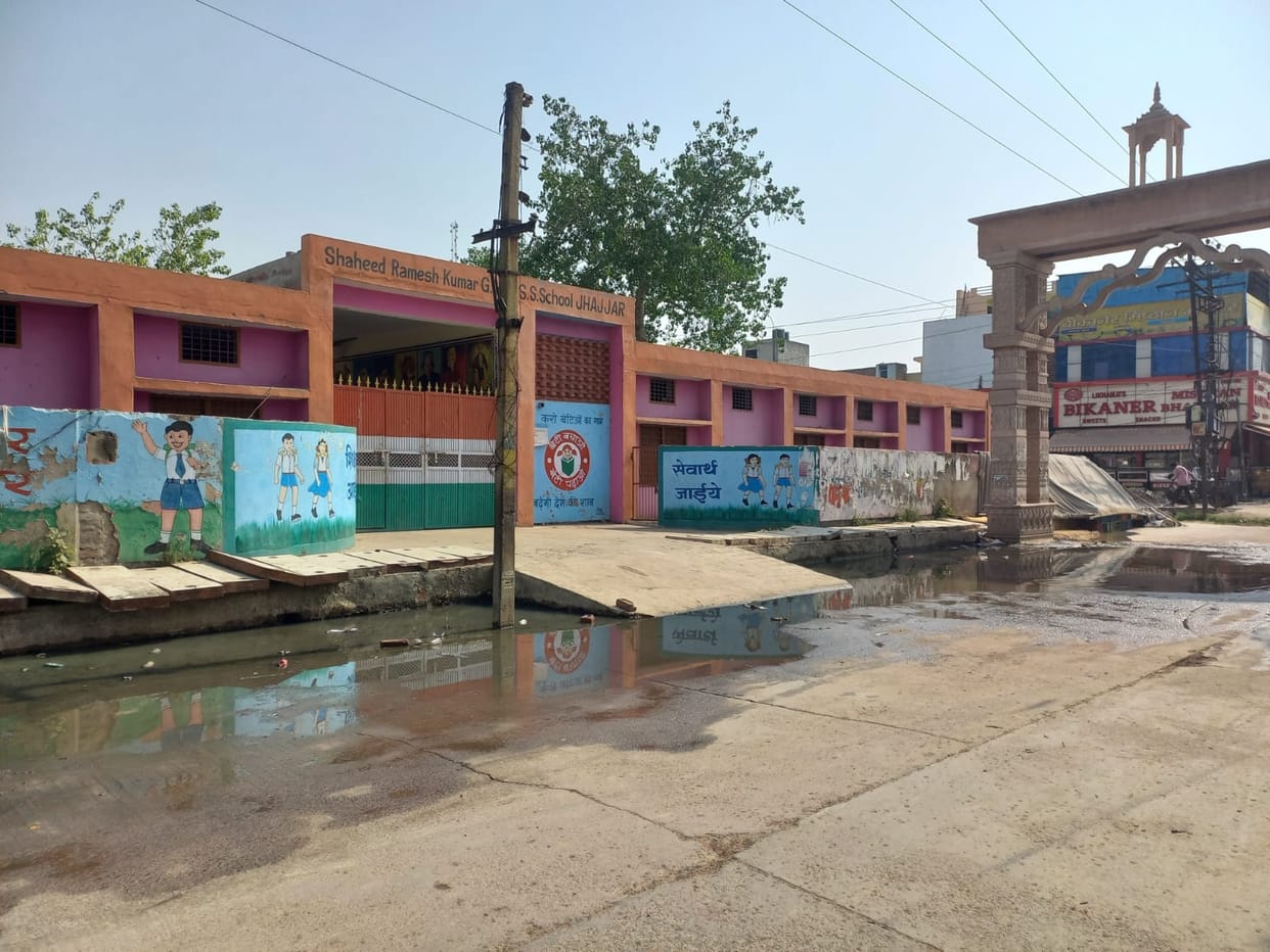 Dirty drain water standing in front of the booths at Bikaner Chowk, one model booth also included