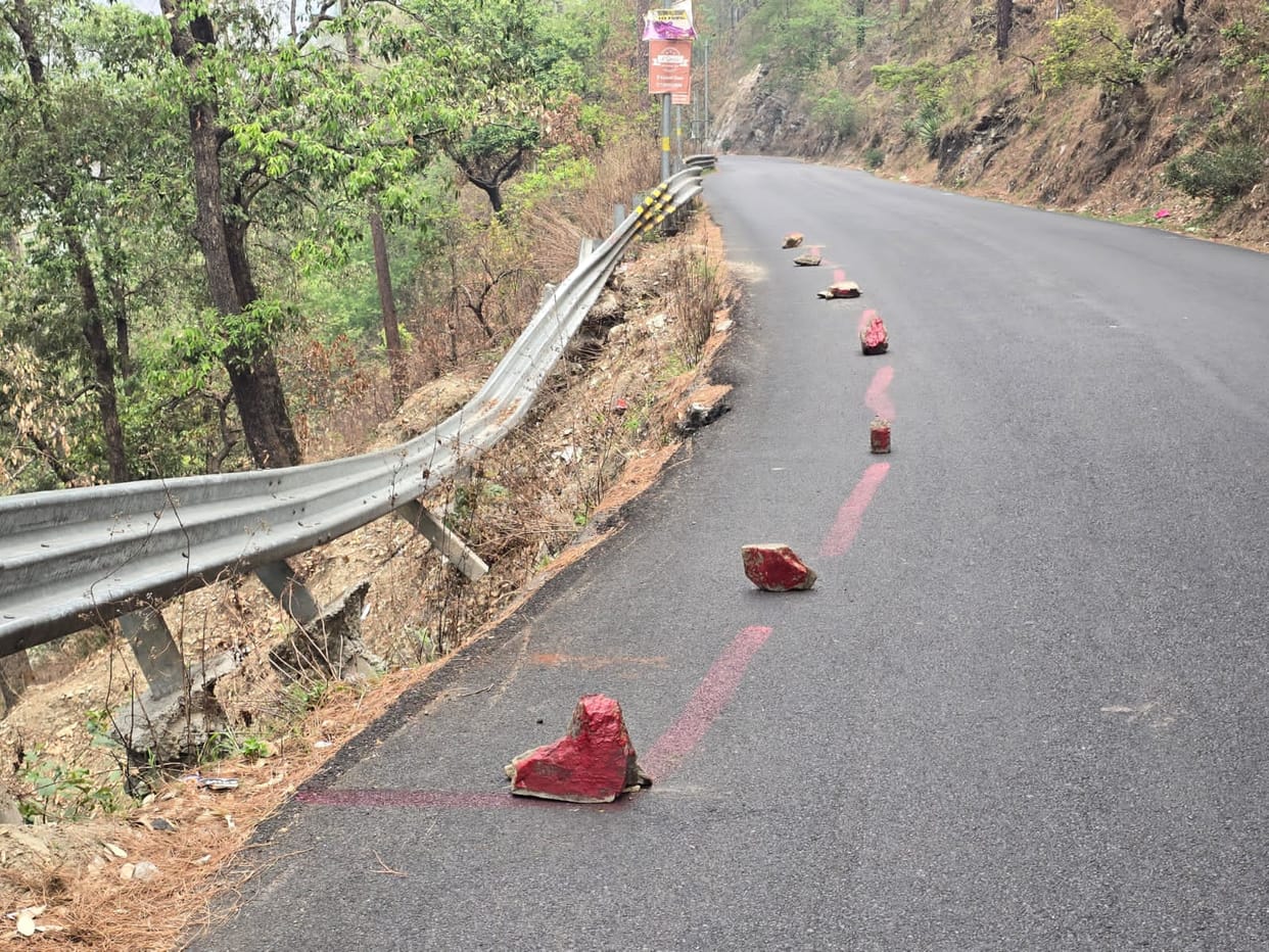 Instead of straightening the crash barrier, stones were placed on the road.