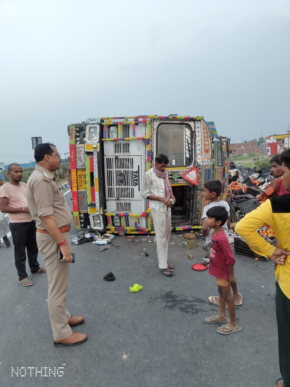 Truck loaded with tomatoes overturns on highway, two drivers injured