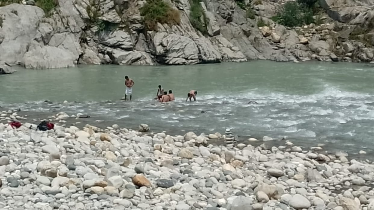 Risky dip in Beas to get relief from heat