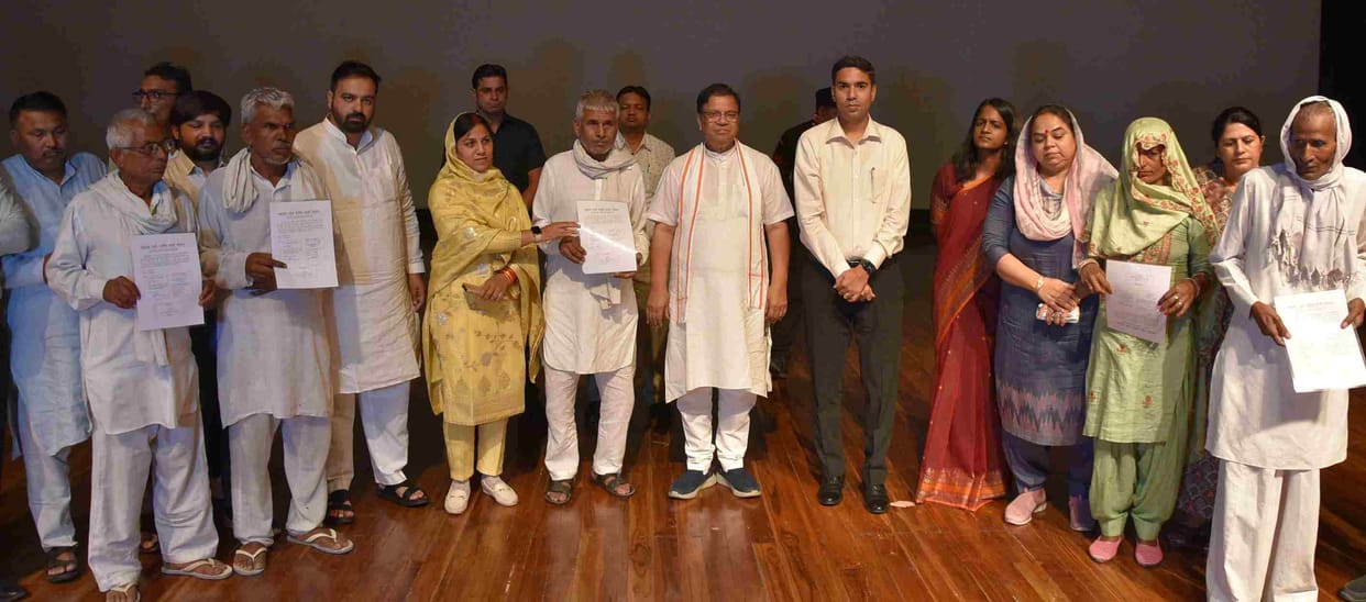 Plot possession certificates distributed to 383 families