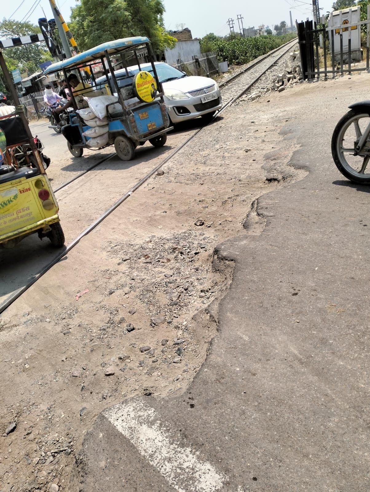 Road potholes near railway track become cause of trouble