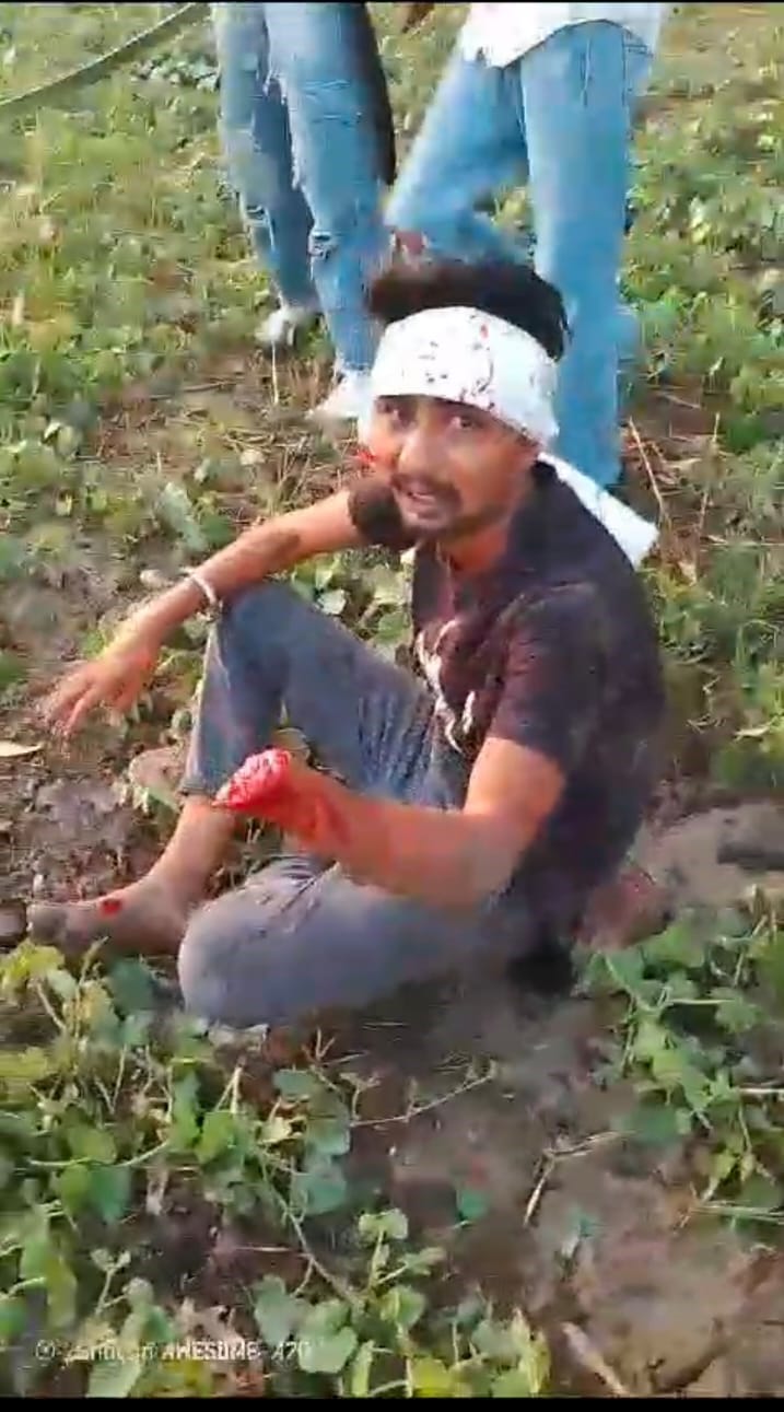 Bloody conflict: Young man's hand cut with a sword, another's head broken