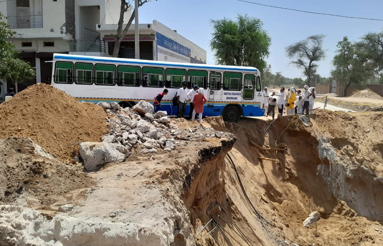 Tire of roadways bus stuck in the pit of under construction bridge, saved from overturning