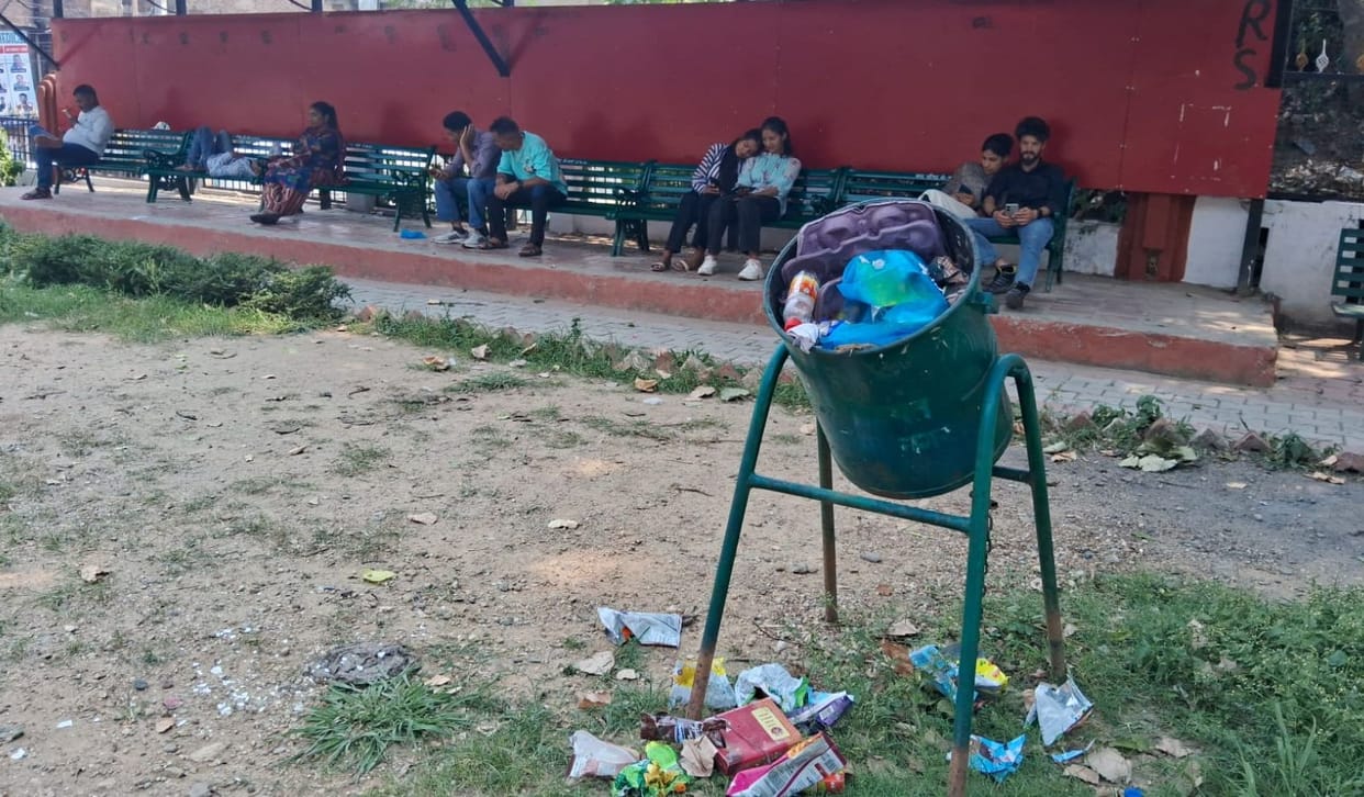 Grass grows in place of water in water fountain, open garbage taints cleanliness