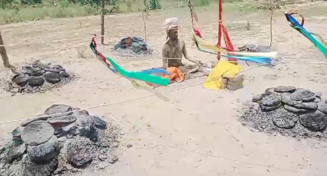 Sadhus sitting in meditation amidst embers in the scorching heat in Pilibhit
