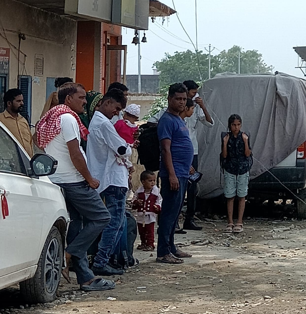 In the absence of a passenger shed, people are forced to wait for buses in the hot afternoon