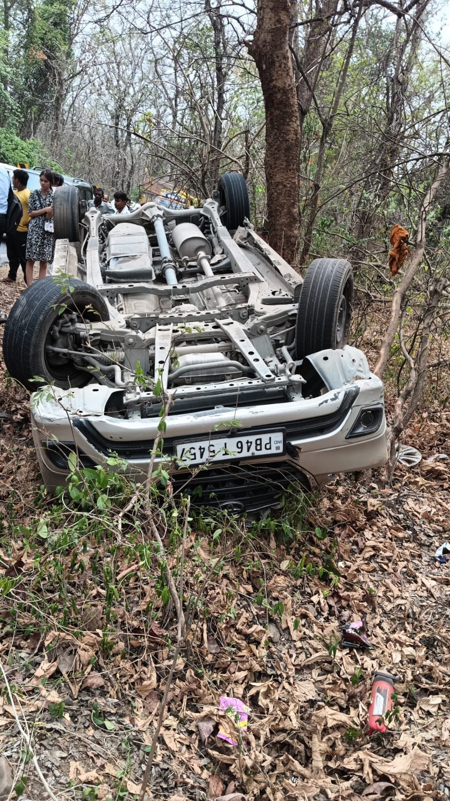 Car overturns after colliding with bike and scooter, eight injured