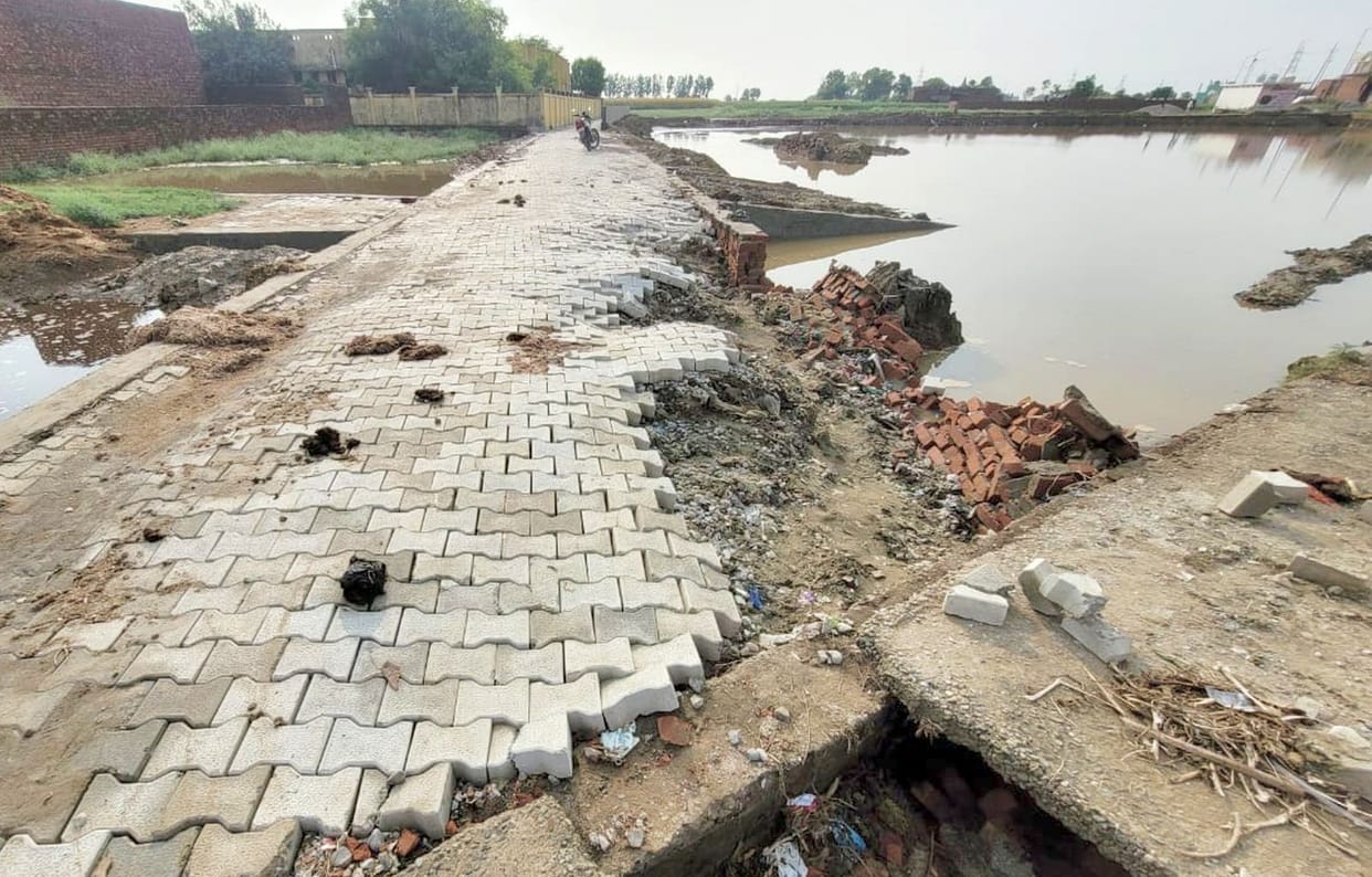 The road caved in during the first rain and the wall also collapsed