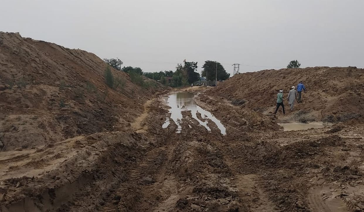 Dumpers have created swamp like conditions on the unpaved roads of the village