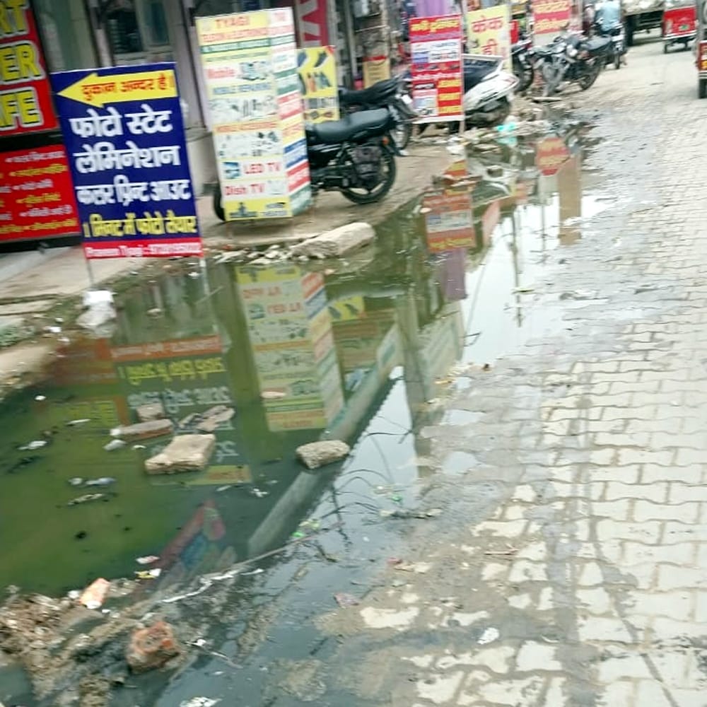 Contaminated water filled outside shops for two months, no solution available