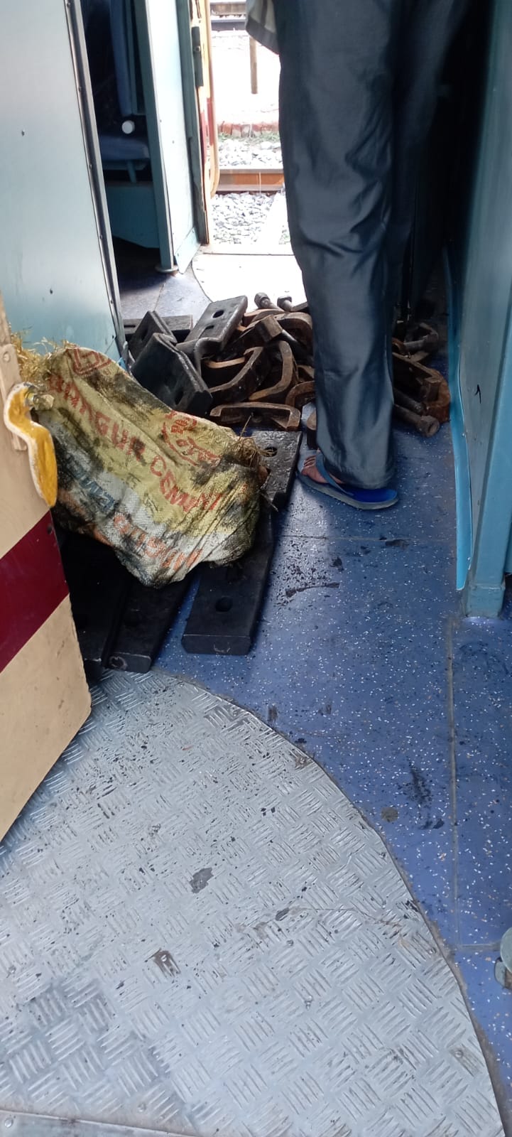 Goods being carried by railway lines in carriages.
