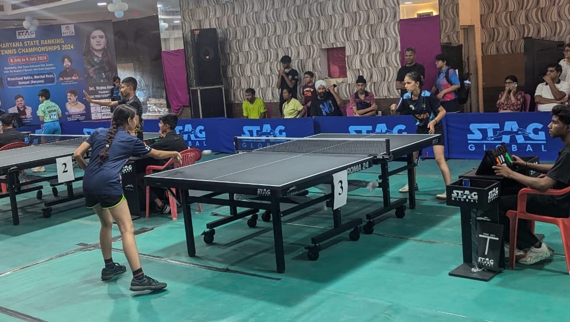 Players hit shots to win in table tennis competition
