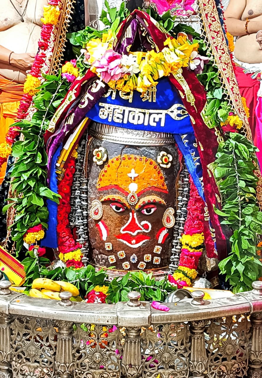 Baba Mahakal dressed as a goddess in Bhasmarti with a bindi on his head and a nose ring