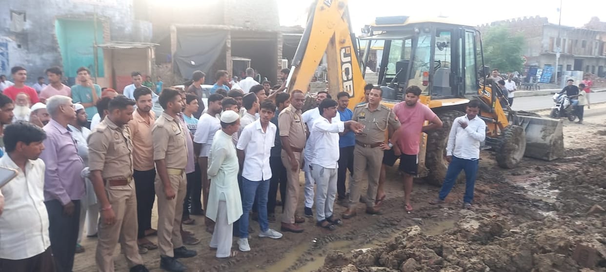 People got angry after the wall of a religious place fell down due to a JCB machine