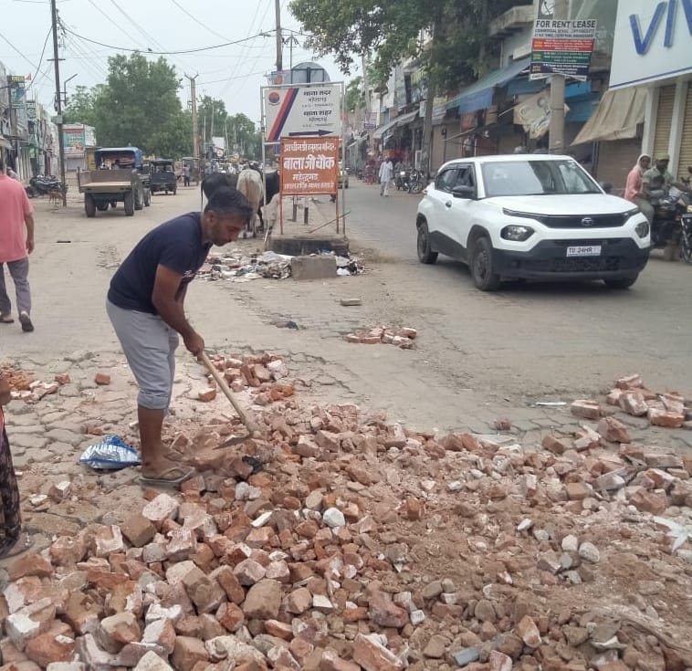 Potholes on dilapidated roads have not been filled for two years, now people are filling the potholes with debris