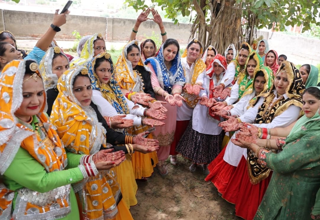 Women apply mehendi on Teej in Madina