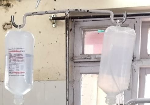 Empty hanging on stand in emergency room 

Glucose bottles, no one is paying attention