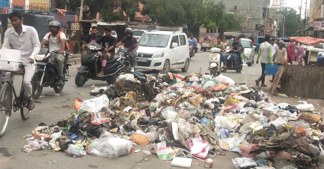 Garbage rots on the road in Garh Pada Mohalla