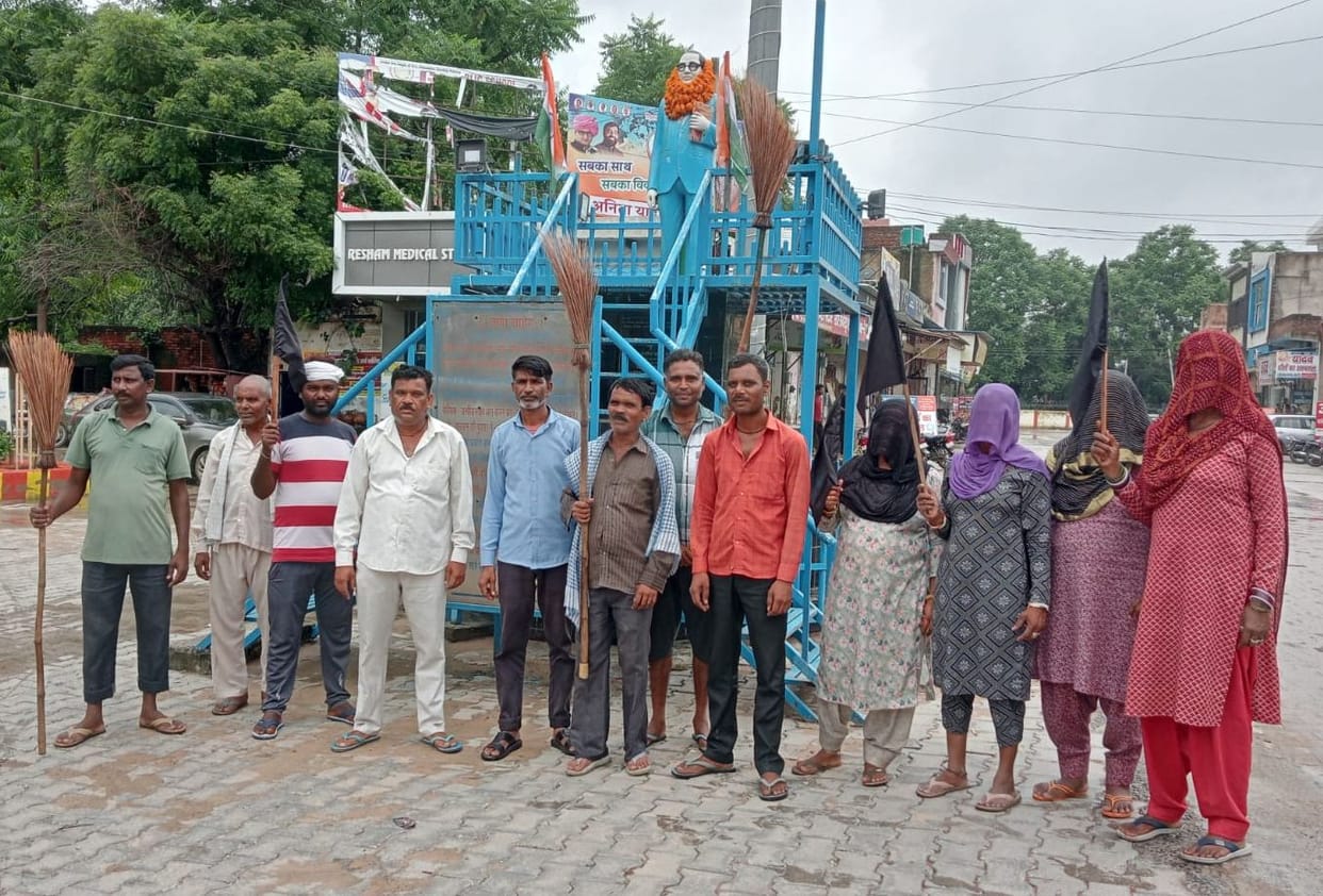 Sanitation workers demonstrated with brooms, expressed anger