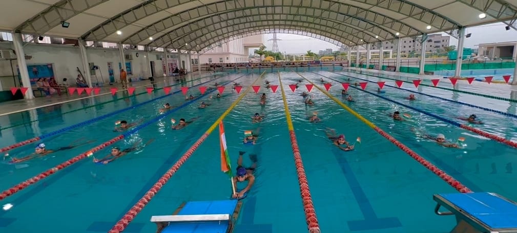 Traveled with tricolor flag in hands while swimming in swimming pool