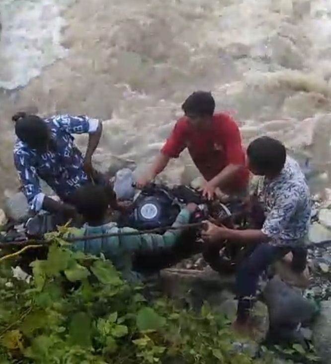 Bike swept into the abyss, biker narrowly escapes