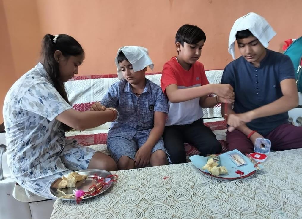 A tilak was applied on the forehead and a protective thread was tied on the brother's wrist
