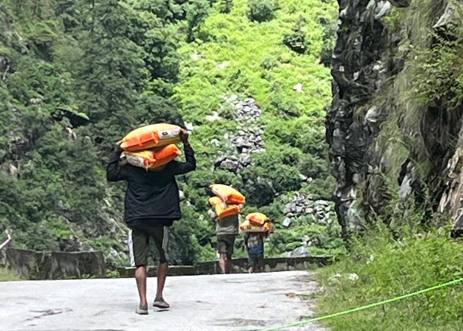 Load on back, rough road, 8 hours walk to deliver ration to Malana
