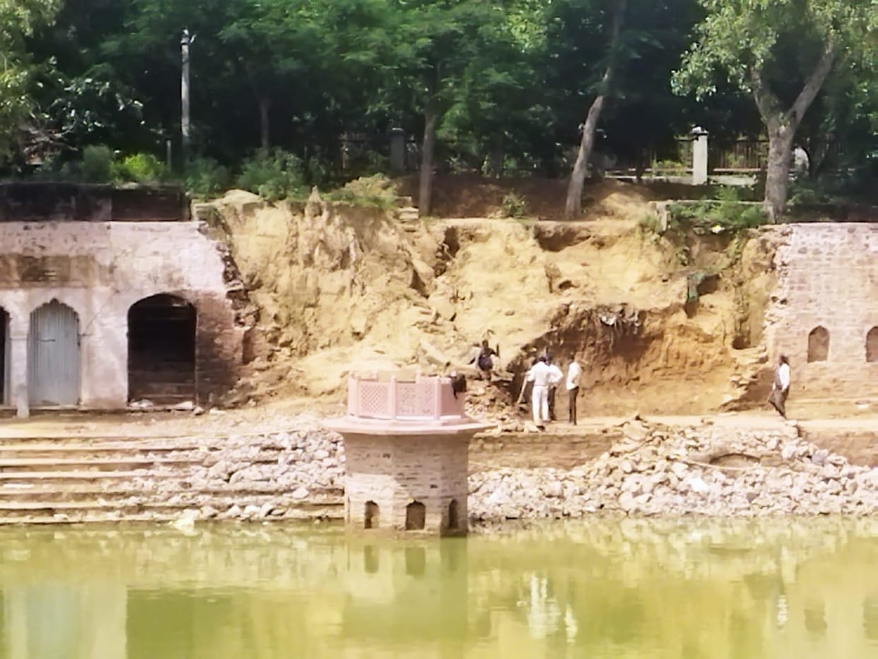 The wall of Solarahi pond is being built on one side and is breaking on the other side