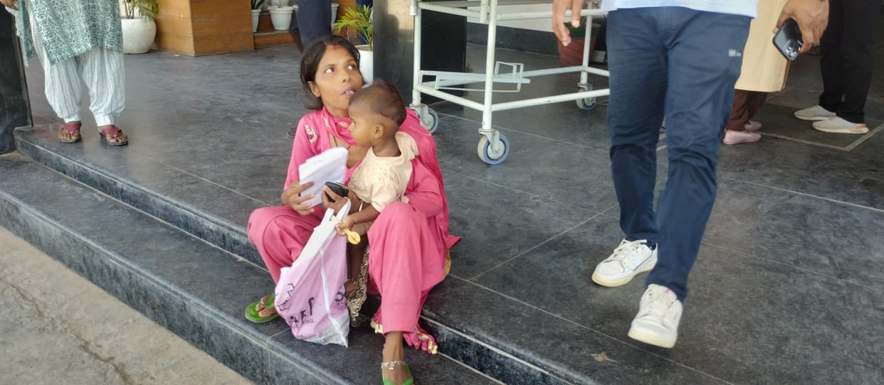 Husband in trouble, child in lap, waiting for ambulance