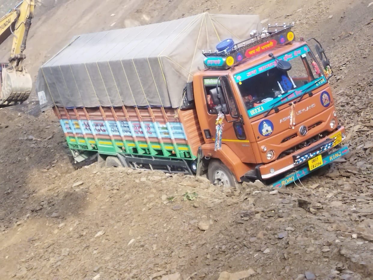 Cargo vehicle stuck in debris from hill near Santola