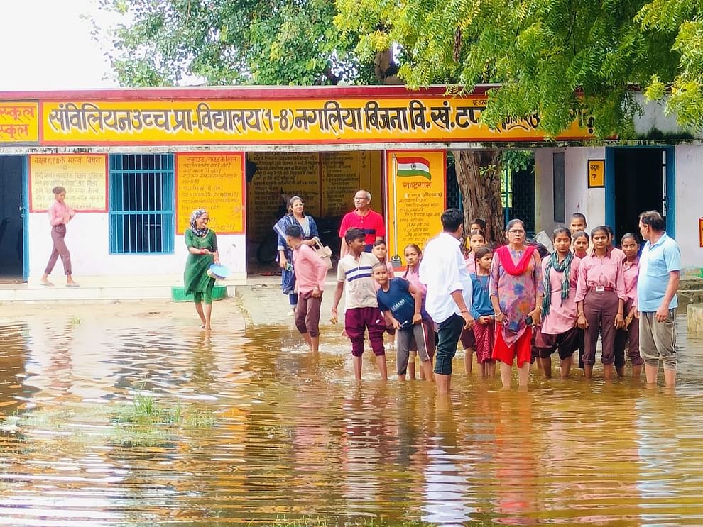 Rain drain choked, schools filled with water