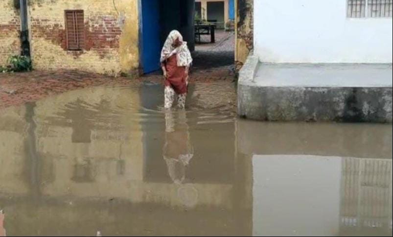Rain caused waterlogging in village Sota, villagers passing through dirty water