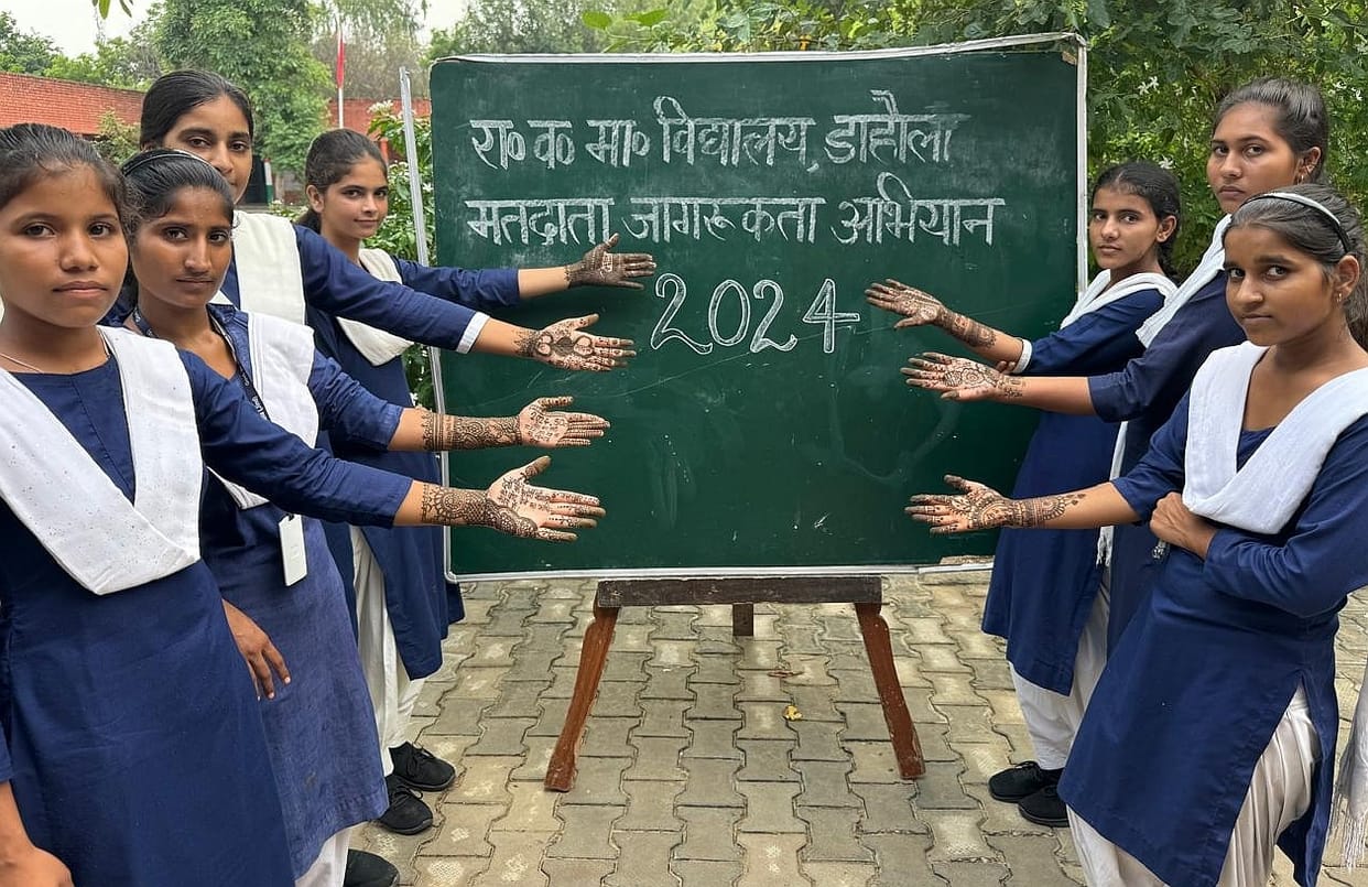 Girl students applied mehendi to create awareness about voting
