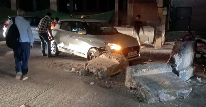 Car collides with divider, driver injured