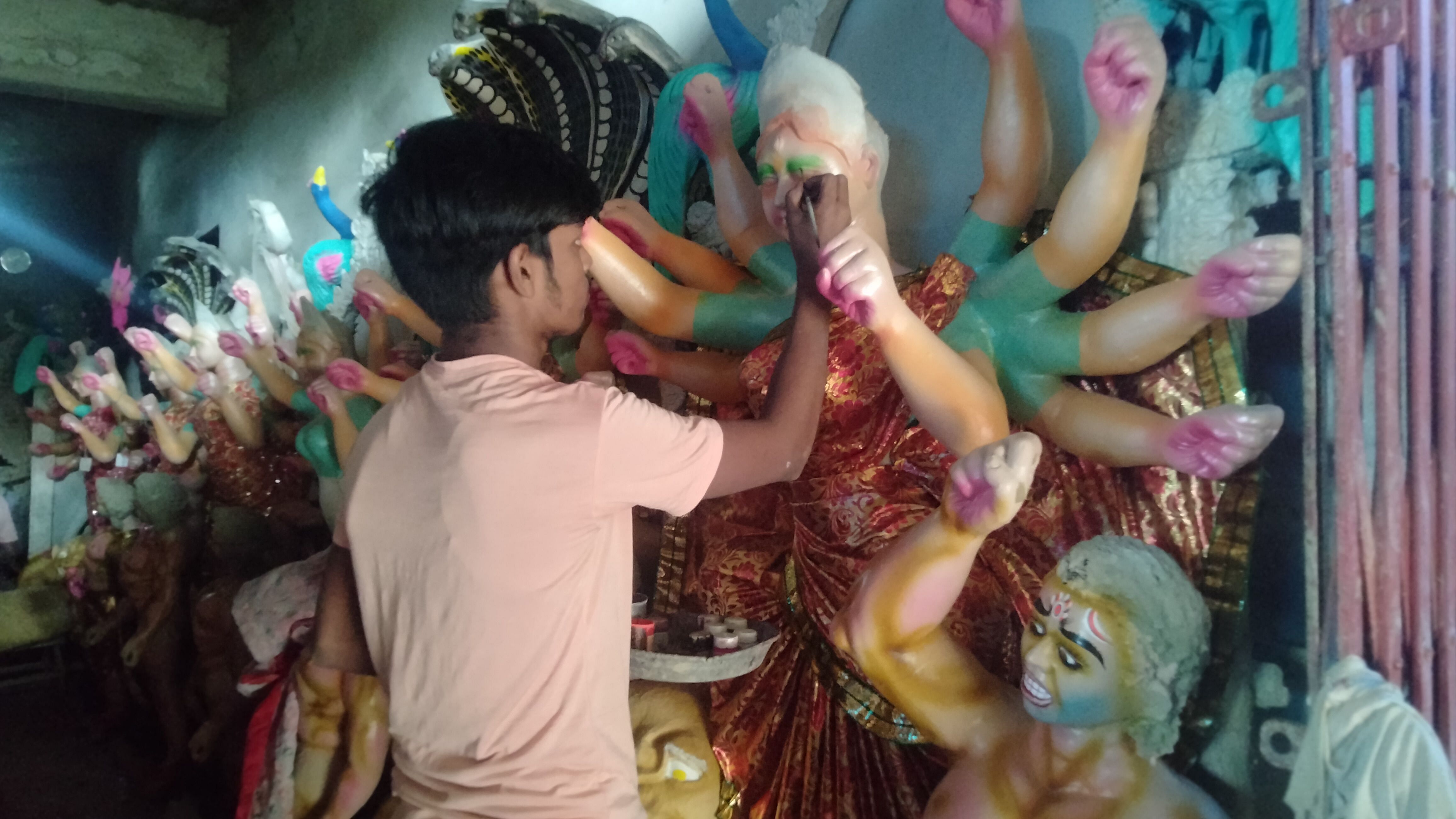 Sculptors engaged in giving final shape to Durga idols