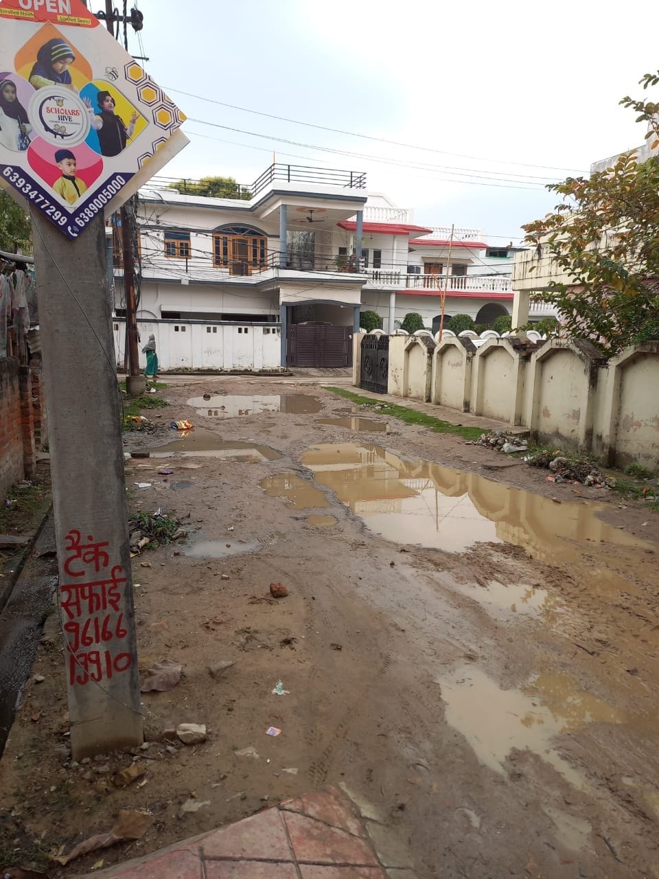 Broken road filled with water, difficult to walk