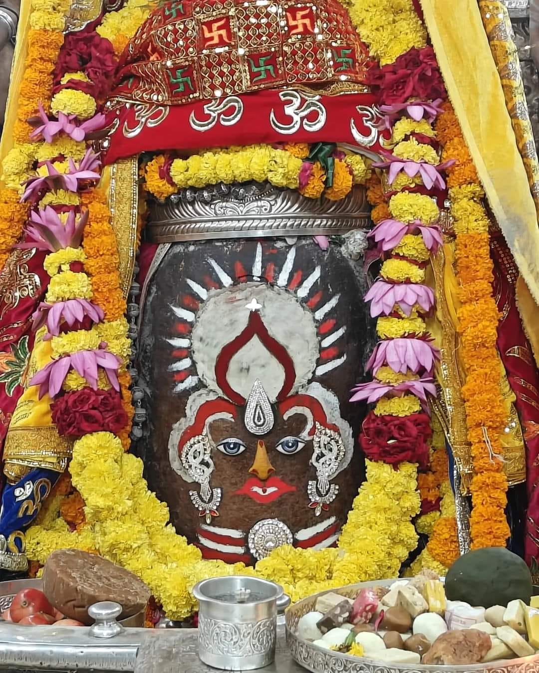 Baba Mahakal decorated with sun on his head and then in Bhasma Aarti