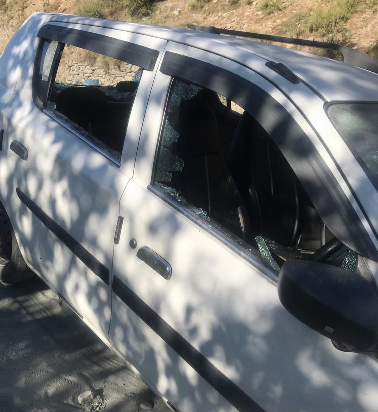 Tempo traveler standing on the roadside was set on fire, glass of the car was broken
