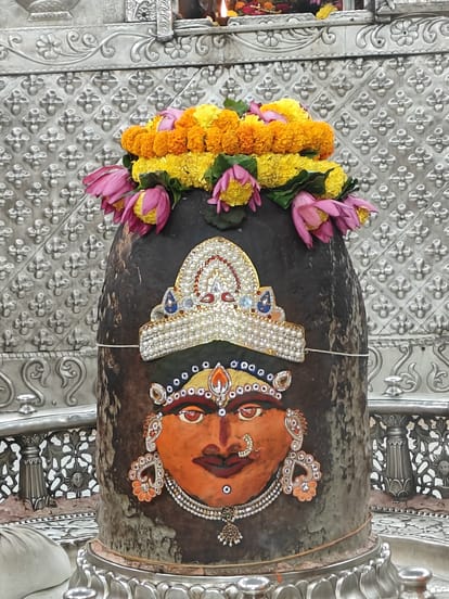 Baba Mahakal dressed as a goddess, wearing a rosary of Rudraksh and also offering lotus flowers