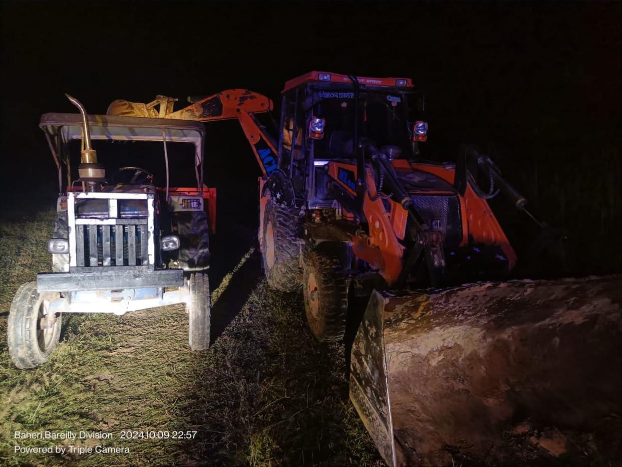 Illegal mining in the forest at midnight, JCB and tractor parked in the police station