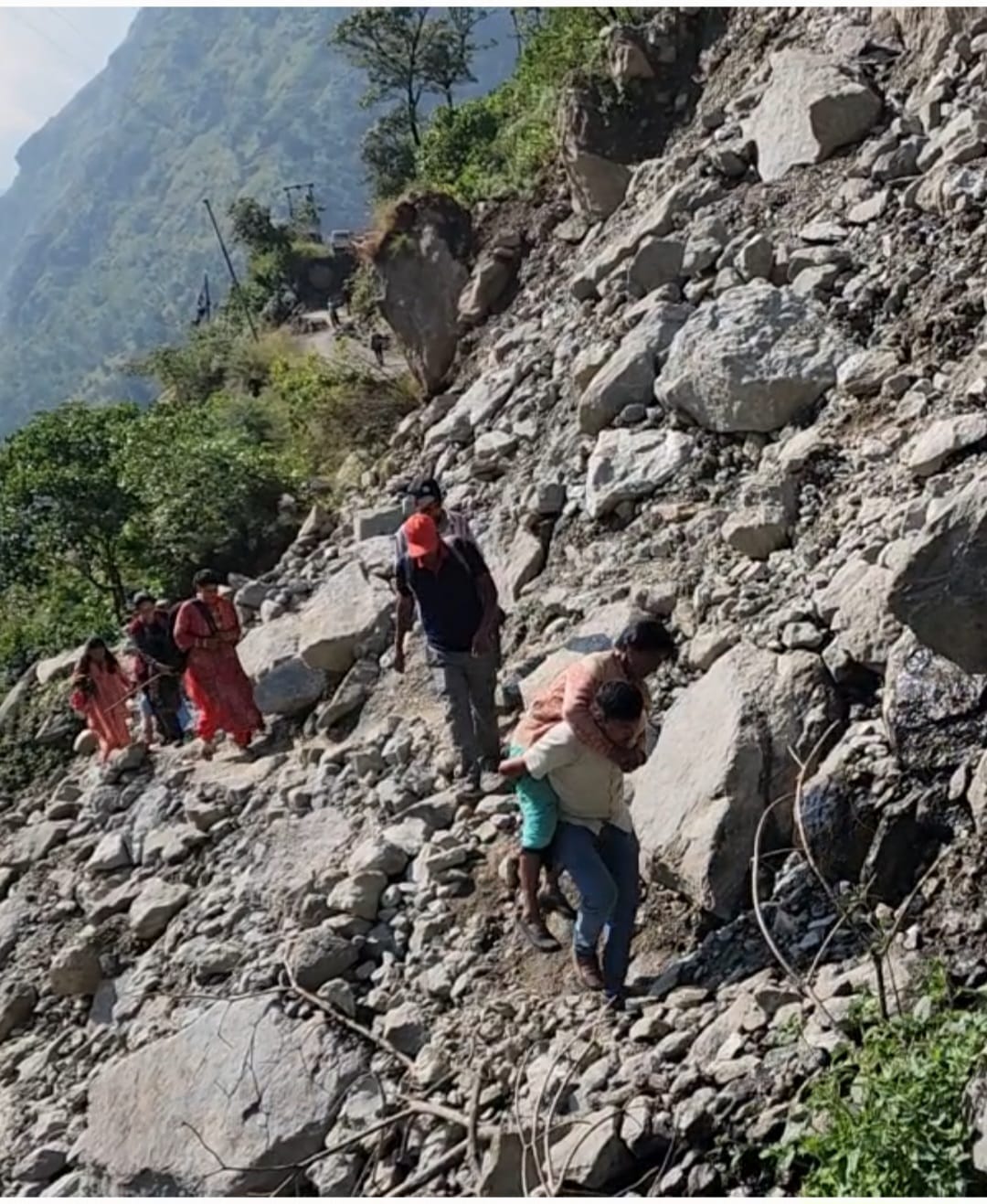 Sick woman from Jumma village was carried to the hospital on her back.