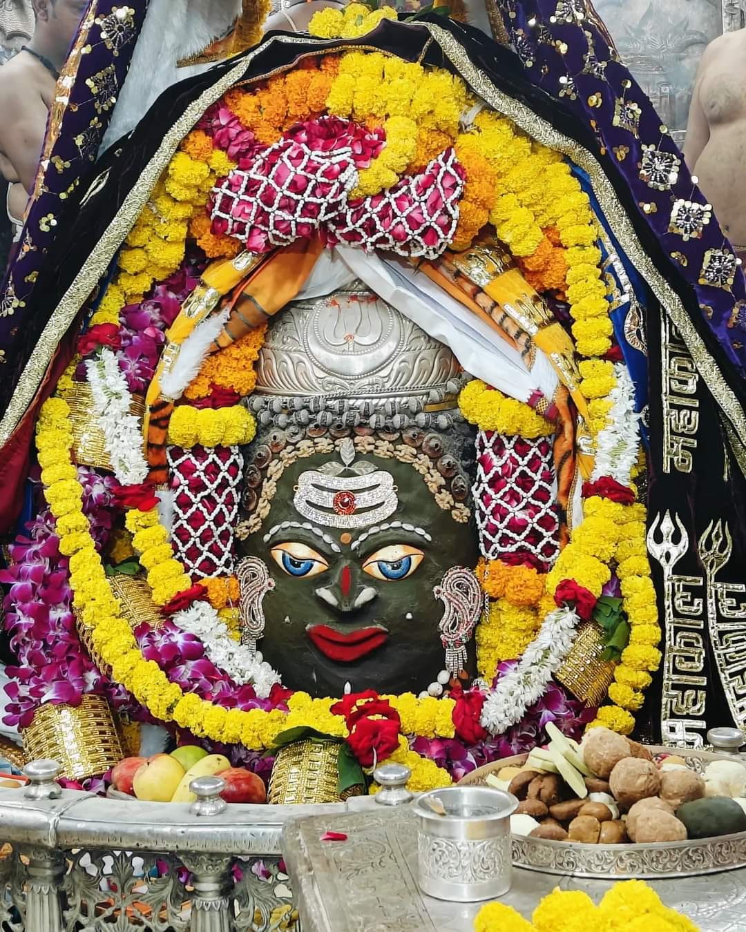 Baba Mahakal adorned with Tripund on his head, garland of roses around his neck
