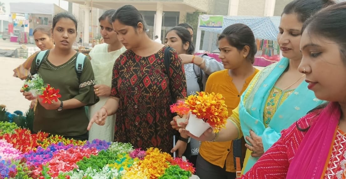 Women and youth learning the skills of handicraft and painting from craftsmen