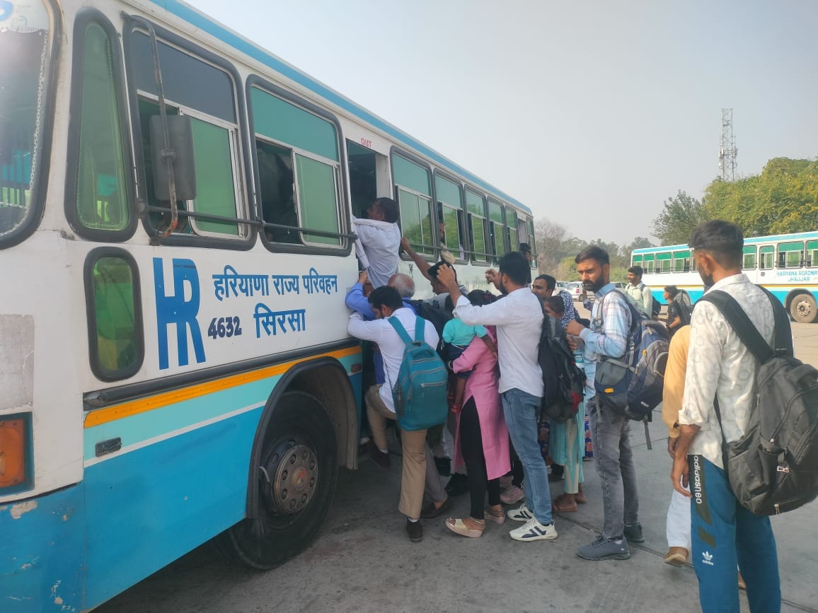 Crowd of passengers at bus stand, queues at counters in Bhiwani and Hisar
