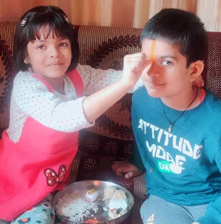 Sisters pray for long life of brothers by taking tilak