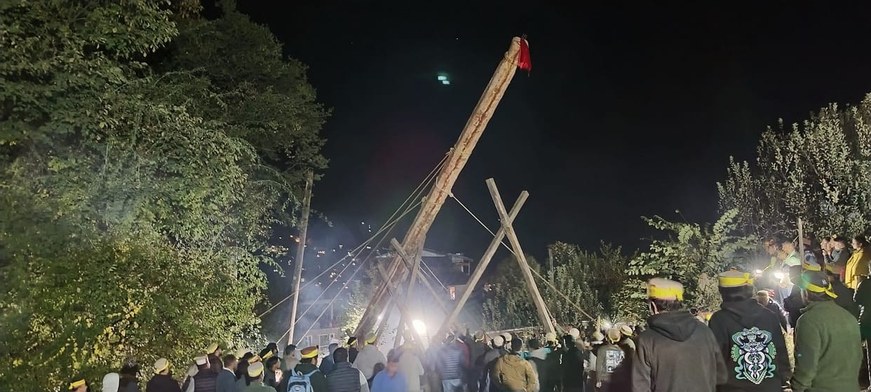 People worked hard for three hours to erect a 73 feet tall flagpole.