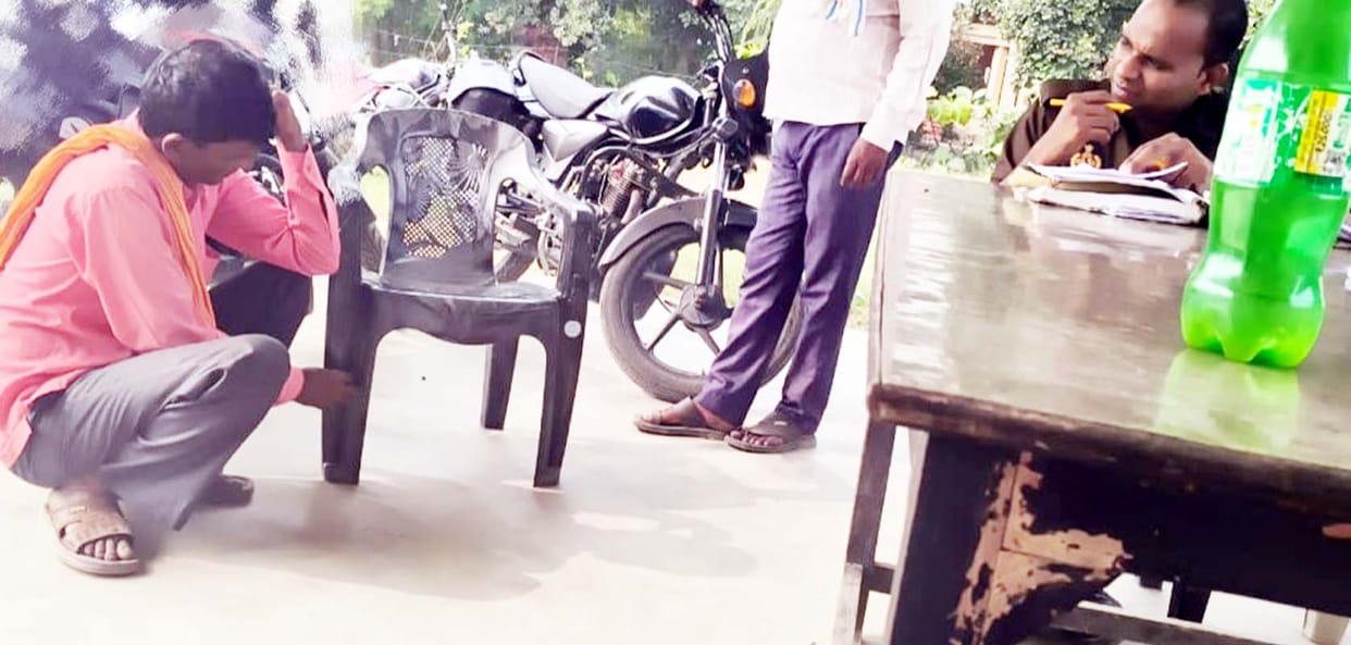constable humiliated man and made him sit on the ground after removing from chair